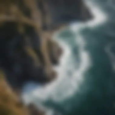 An aerial image of the dramatic coastline, highlighting rocky cliffs meeting the ocean's waves.