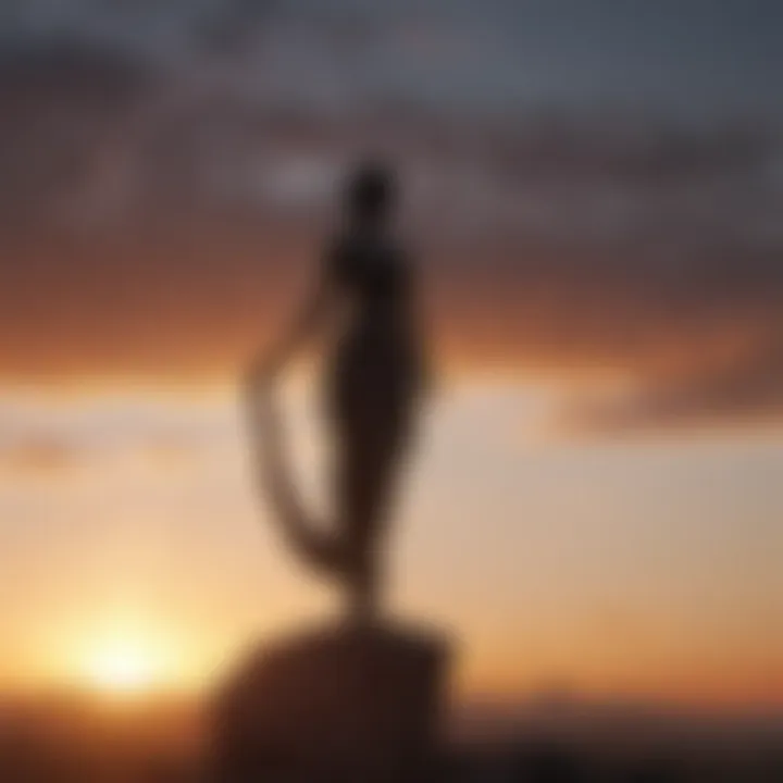 Graceful tall thin statue against a dramatic sunset backdrop